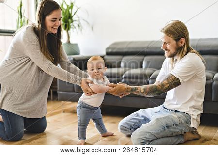 Parent Help Baby Daughter Take First Steps At Home