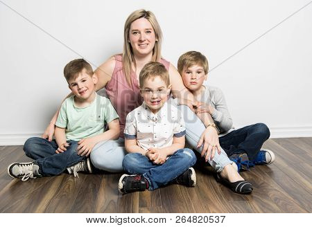 Caucassian Mother With Child Boy On Studio White