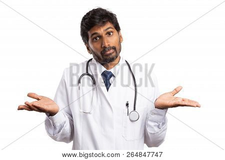 Medic Or Doctor With Perplexed Expression On Face And Palms Up Isolated On White Studio Background