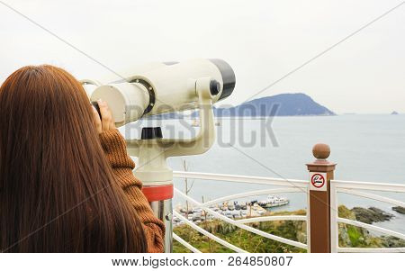Binoculars. Young Girl Use Binocular Looking To The Island View At Oryukdo Islands In Busan, South K