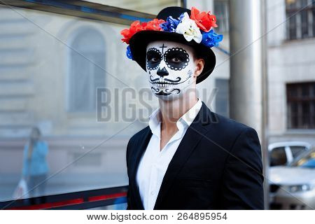 A Man With A Painted Face Of A Skeleton, A Dead Zombie, In The City During The Day. Day Of All Souls