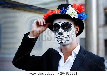 A Man With A Painted Face Of A Skeleton, A Dead Zombie, In The City During The Day. Day Of All Souls
