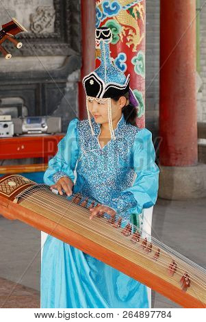 Ulaanbaatar, Mongolia - August 16, 2006: Unidentified Lady Wearing Traditional Costume Performs Musi