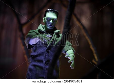 OCT 21, 2018: MEGO Corp Frankenstein Monster action figure walking through a haunted forest. 