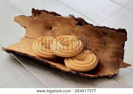 Delicious Crumbly Shortbread Homemade Cookies On Pine Bark. Light Wooden Background.