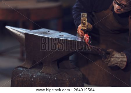 Metalworker Forming A Coil With Hot Metal