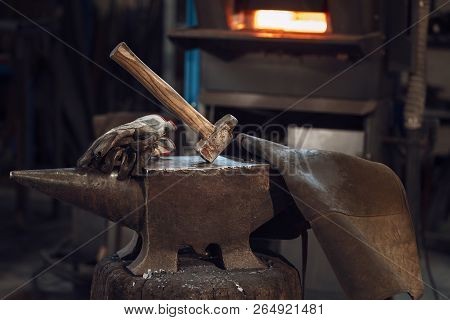 Mallet On An Anvil In Front Of A Furnace