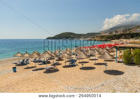 Himare, Albania- 29 June 2014: Sunbathers On The Beach In Himare Resort. Stony Beach On The Adriatic