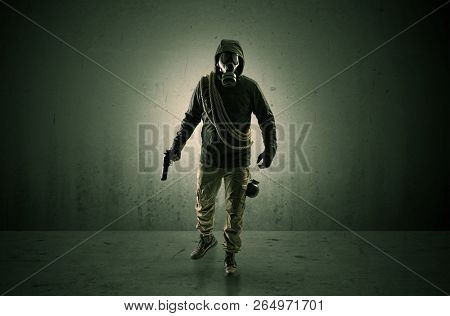 Bad agent in a dark room with arms on his hand and gas mask