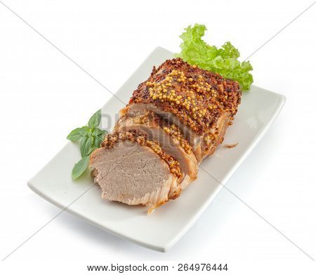 Baked Pork With Frebch Mustard, Basil And Lettuce On The White Plate