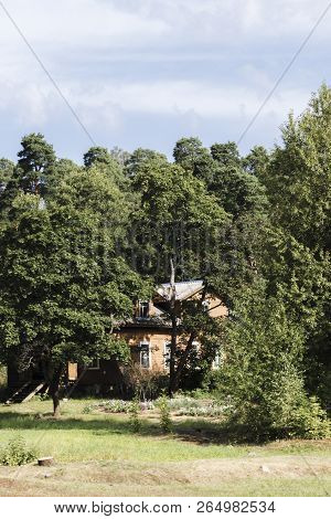 House In The Forest Among The Trees. Summer.
