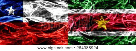Chile, Chilean Vs Suriname, Surinamese Smoke Flags Placed Side By Side. Concept And Idea Flags Mix