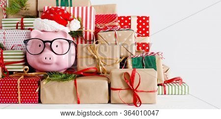 Piggy Bank And A Lot Of Gift Boxes. Christmas Decor. White Background. Fir Branches.
