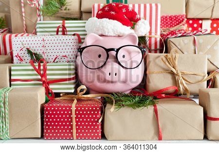 Piggy Bank And A Lot Of Gift Boxes. Christmas Decor. White Background. Fir Branches.