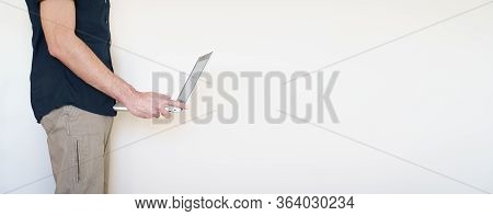 Male Digital Nomad Hand Holding A Laptop