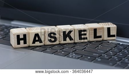 Concept Word Haskell On Cubes Against The Background Of Laptop Keys. Technology Concept.