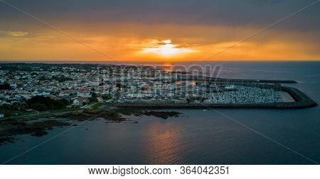 Warm And Cloudy Sunset Faces The Harbor Of The Wonderful Yeu Island In France, West Coast
