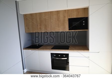Closeup Of Kitchen Interior In New Apartment. Small And Compact Furniture For Flat. Modern Black Coo