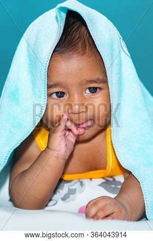 A Six Months Age Asian Baby Boy Playing A Yellow Taddy Bear.