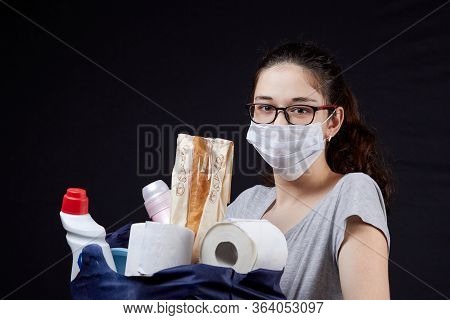 Young Woman In Protective Mask With A Bag Full Of Groceries From The Supermarket