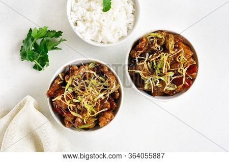 Spicy Garlic Fried Chicken (kkanpunggi). Asian Chicken In Sweet And Sour Sauce In Bowl Over White Ba