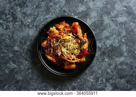 Spicy Garlic Fried Chicken (kkanpunggi). Asian Chicken In Sweet And Sour Sauce On Plate Over Dark St