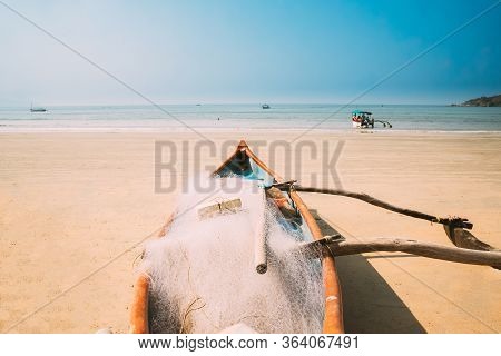 Canacona, Goa, India. Wooden Fishing Boat With Net Parked On Famous Palolem Beach In Summer Sunny Da