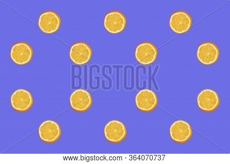 Colorful Fruit Pattern Of Fresh Lemon Slices On Blue Background. From Top View