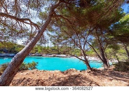 View Of The Famous Beach Cala Turqueta. (focus On Foreground, People On The Beach In Blur). Menorca,