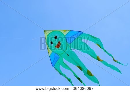 Children\'s Toy. Children Fly A Flying Kite.\nbackground Image For Web Design.