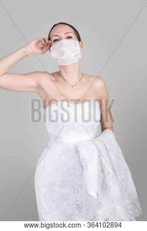 Beautiful Young Bride In A Wedding Dress And A White Medical Mask On Face