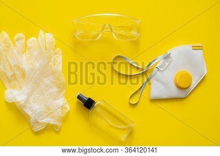 Respirator Ffp, Rubber Gloves, Antiseptic And Protective Glasses Lie On A Pink Background. Anti-viru