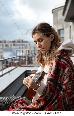 Young Caucasian Hipster/hippie Woman In Casual Clothes Playing Hawaiian Guitar, Sings A Song On A Uk
