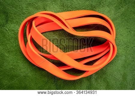 resistance exercise band for fitness and rehabilitation against green background