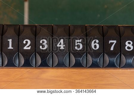 A Black Number Slider On A Table Of The Game Of Foosboll (fusbol) Top View. Number Sequence Concept.