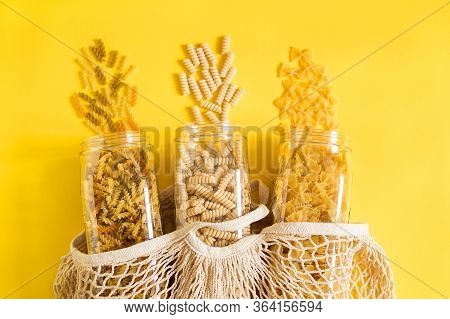 Diffirent Types Of Pasta On Yellow Background.