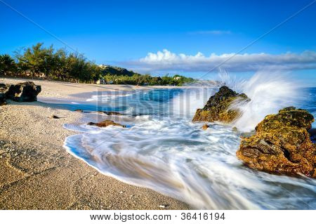 Onde che lambiscono la spiaggia di sabbia di Boucan Canot sull'isola di Reunion, nell'Oceano Indiano.