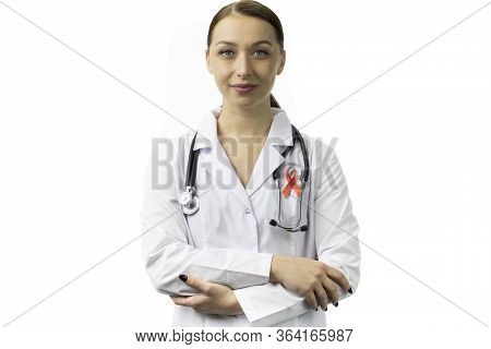 30s Female Doctor With Red Ribbon For Aids Hiv Awareness On White Background Isolated. Symbol Of Awa