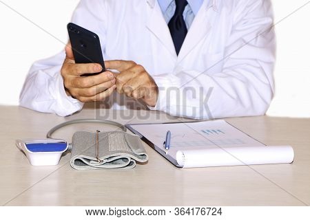 Close-up - A Doctor In A White Coat Measures A Patient's Blood Pressure
