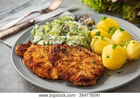 Chop Pork Cutlets , Served With Boiled Potatoes And Salad.