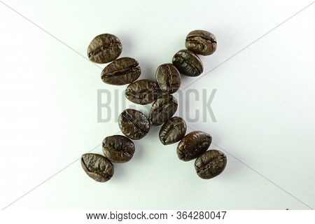 Letter Xwith Coffee Beans On White Background