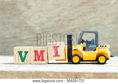 Toy Forklift Hold Letter Block I To Complete Word Vmi (abbreviation Of Vendor Managed Inventory) On 