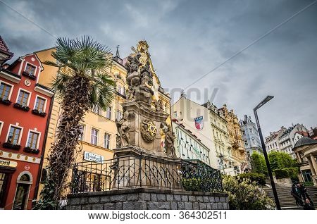 Karlovy Vary, Czech Republic, May 9, 2019: Holy Trinity Column Near Market Colonnade Trzni Kolonada 