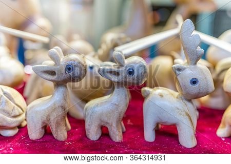 A Selective Focus Of Wooden Reindeer Sculptures Displayed In A Souvenir Shop In Ci Qi Kou Old Town, 