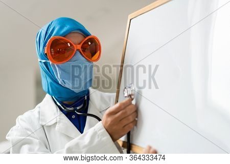 Muslim female doctor with blank whiteboard