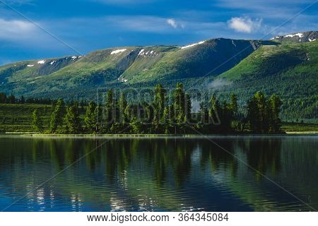 The Forest Is Reflected In The Waters Of A Mountain Lake In The Ulagansky District Of The Altai Repu