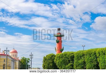 Rostral Column On Strelka Arrow Of Vasilyevsky Island With Green Trees In Saint Petersburg Leningrad