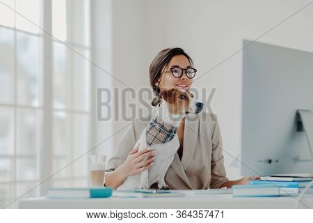 Busy Female Teacher Wears Formal Clothes And Spectacles Conducts Online Lessons For Students Works A