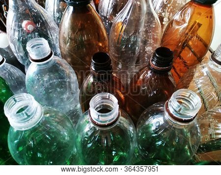 Plastic Bottles Without Caps Top View Horizontal Photo. Recycling Plastic. Green, Brown And Transpar