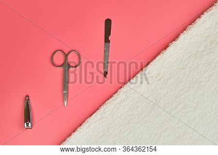 Manicure Tools With White Towel On Pink Background